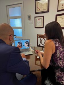 Dr. Samaha showing a patient a preview of their rhinoplasty results